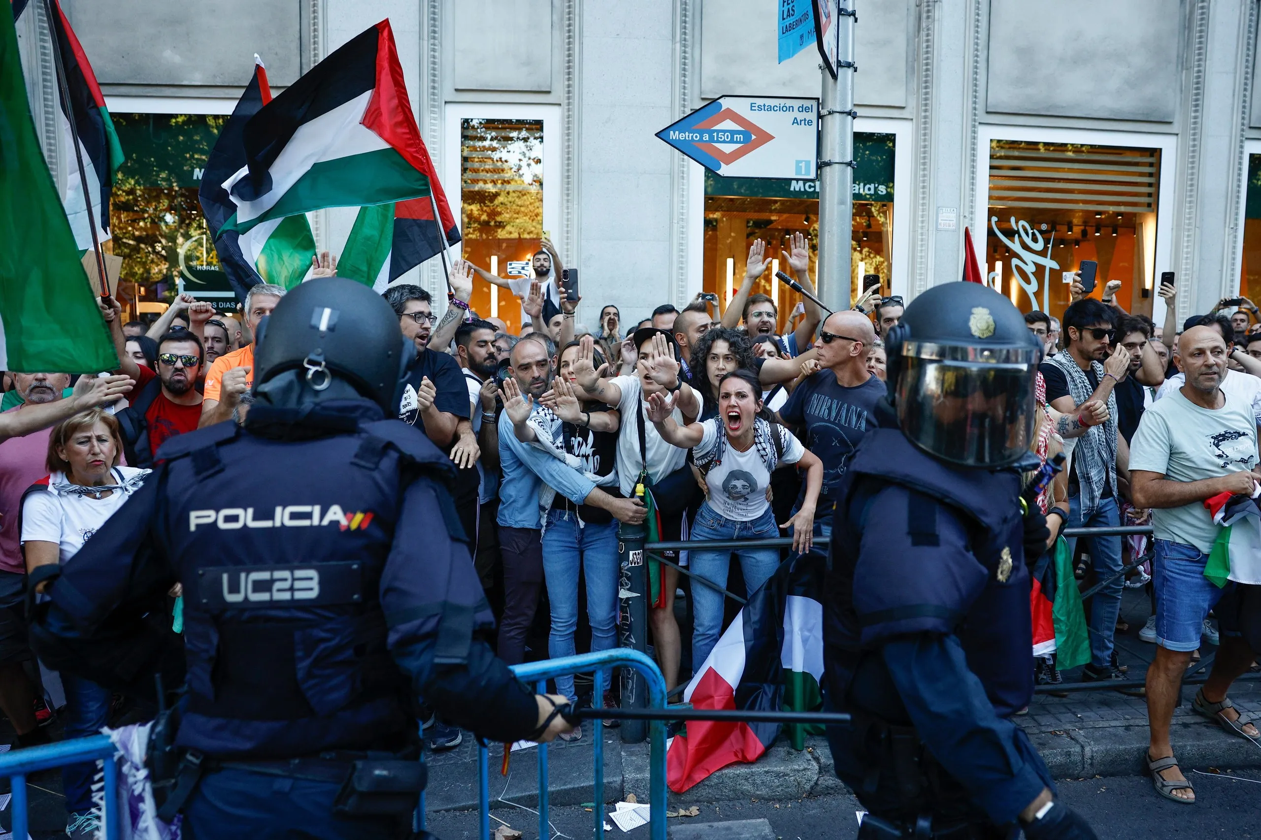 Protesters scream at police in Madrid.