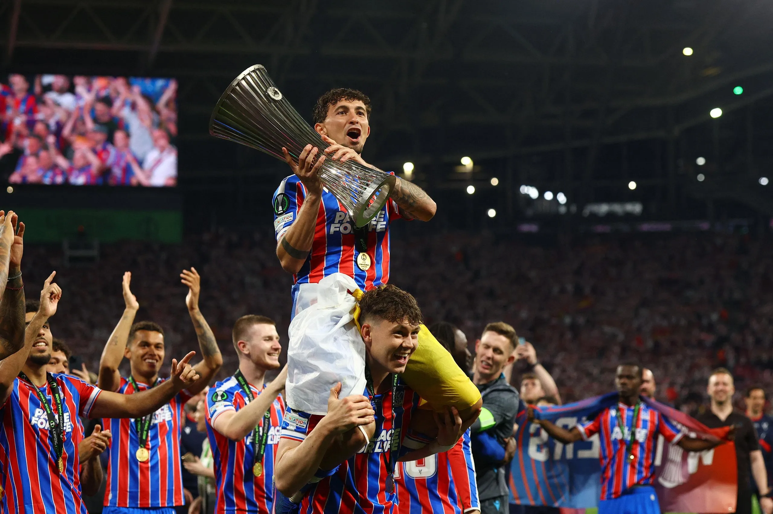 Crystal Palace's Yeremy Pino lifts the trophy as he celebrates with Jorgen Strand Larsen after winning the UEFA Conference League.