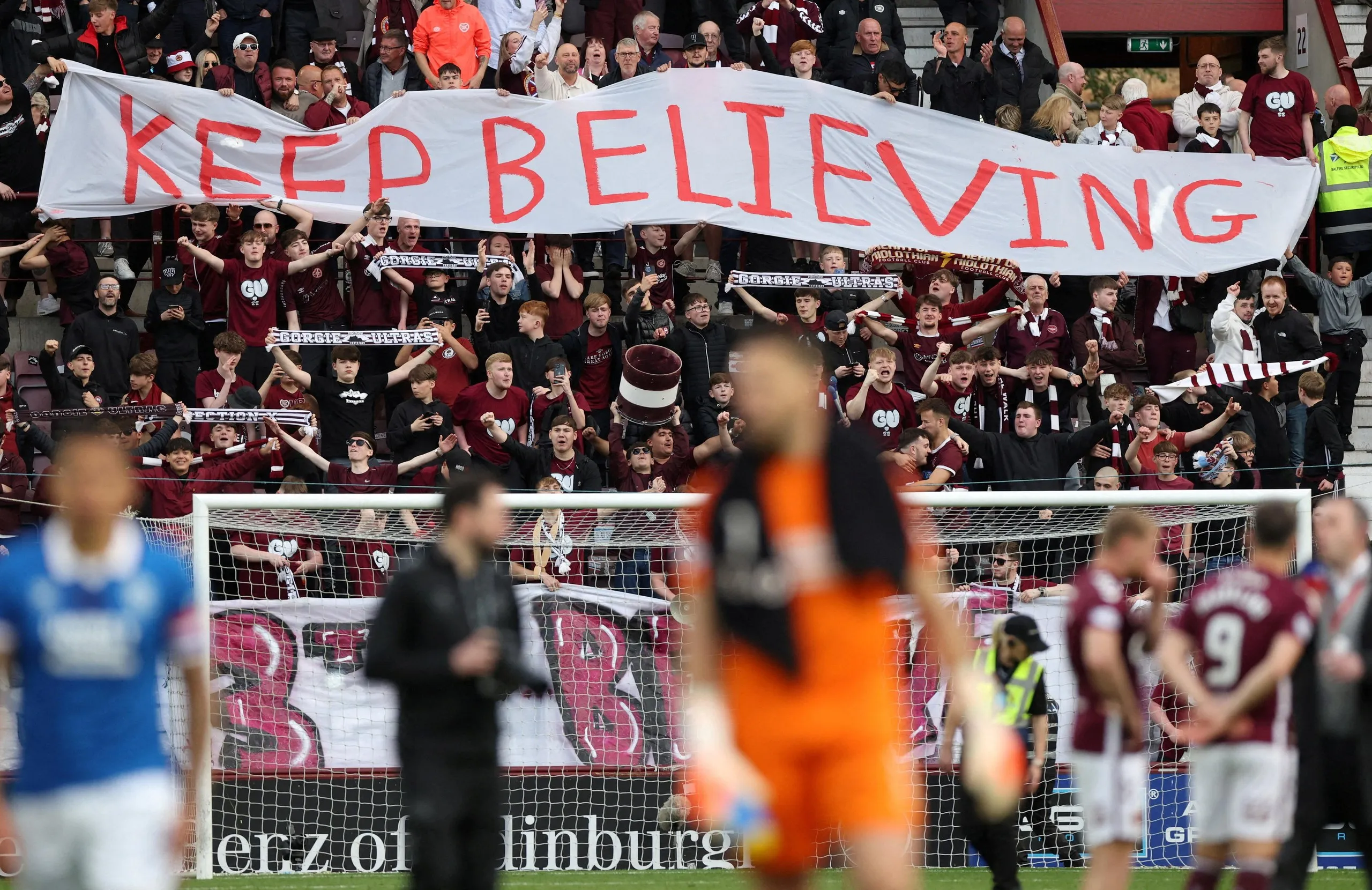 Heart of Midlothian fans display a banner reading “keep believing” in the stands after the match against Rangers