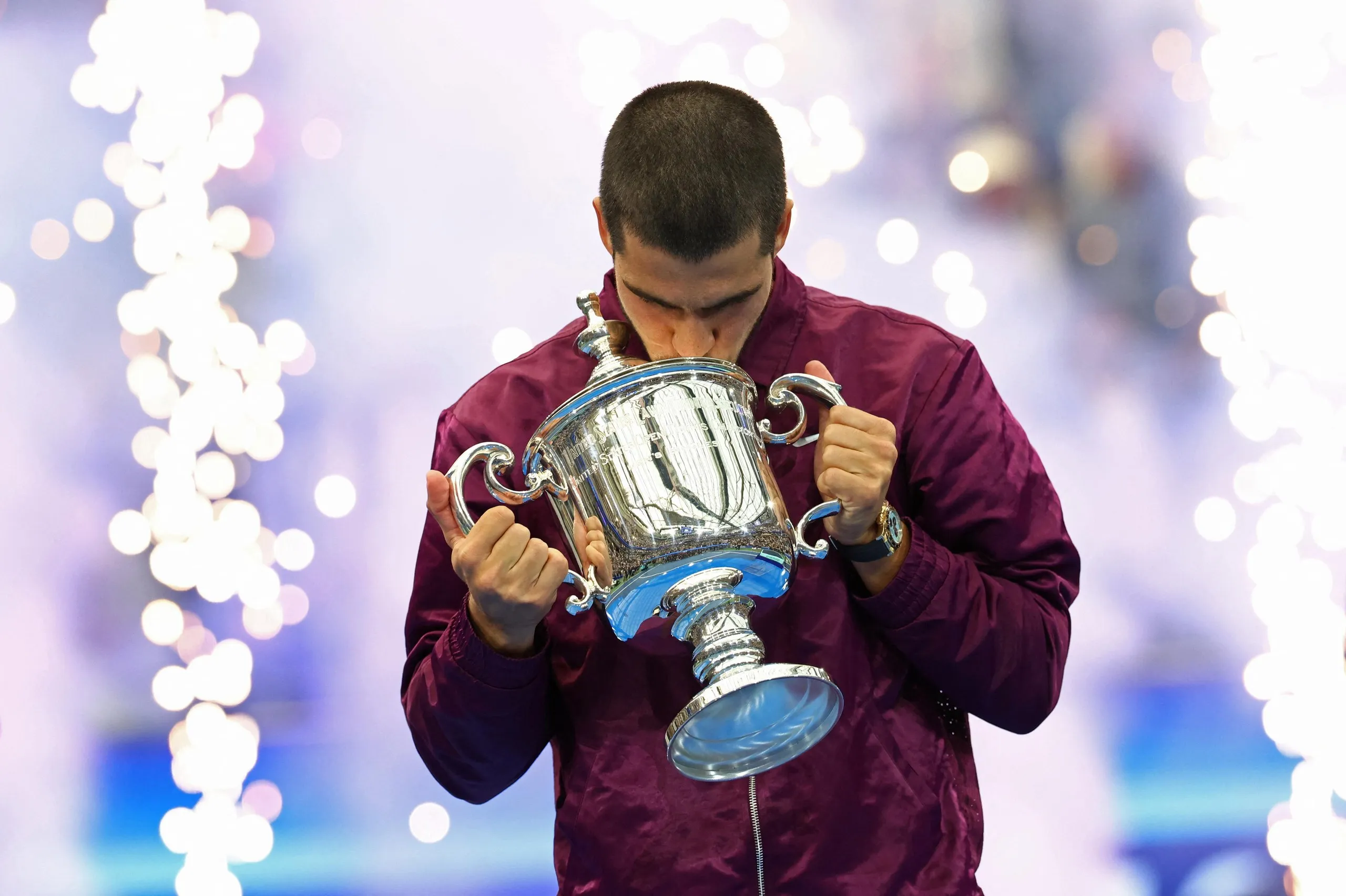 Alcaraz celebrates with the trophy.