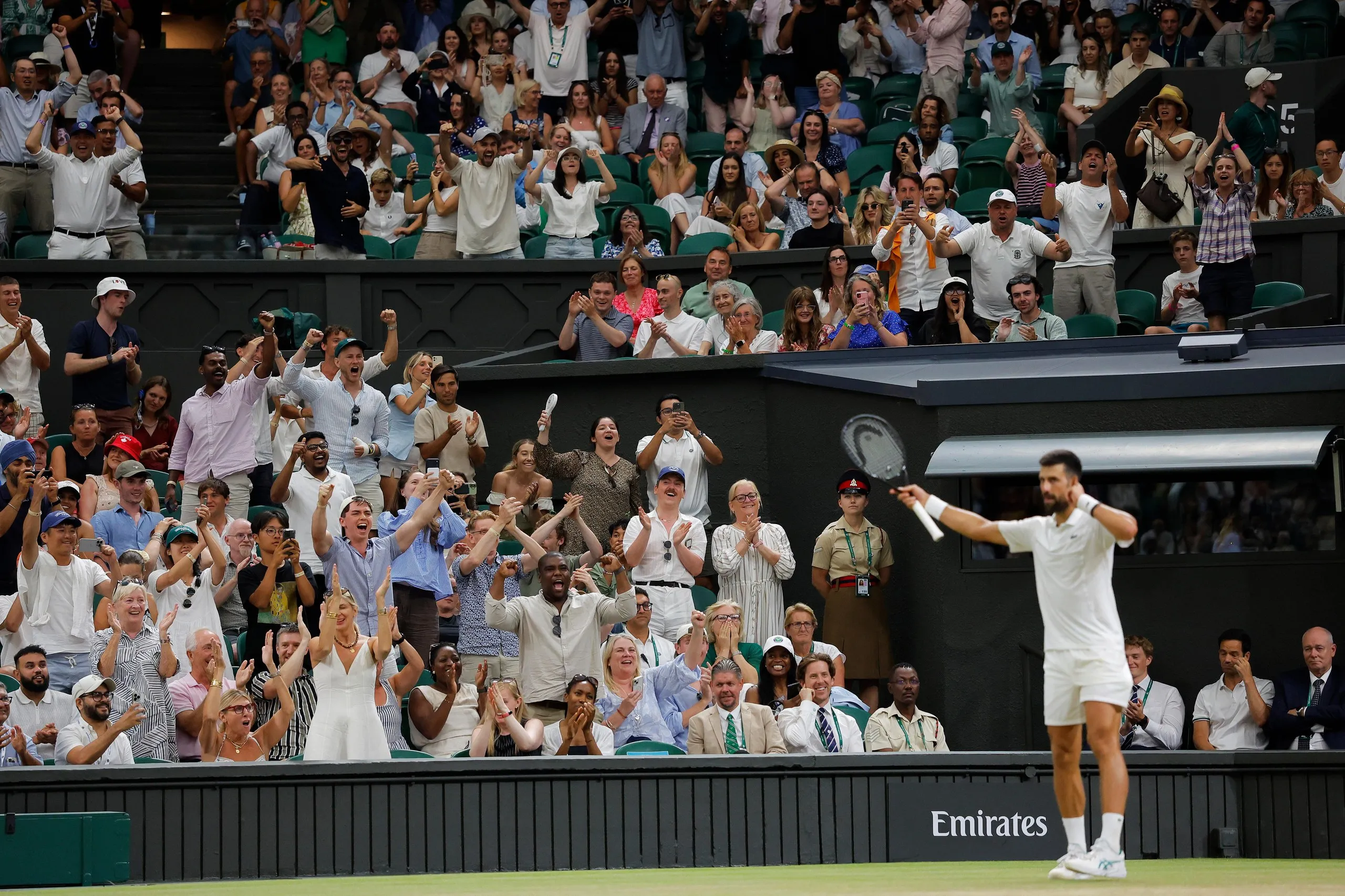 The Centre Court crowd cheer on Novak Djokovic during the quarter-final against Felix Auger-Aliassime.