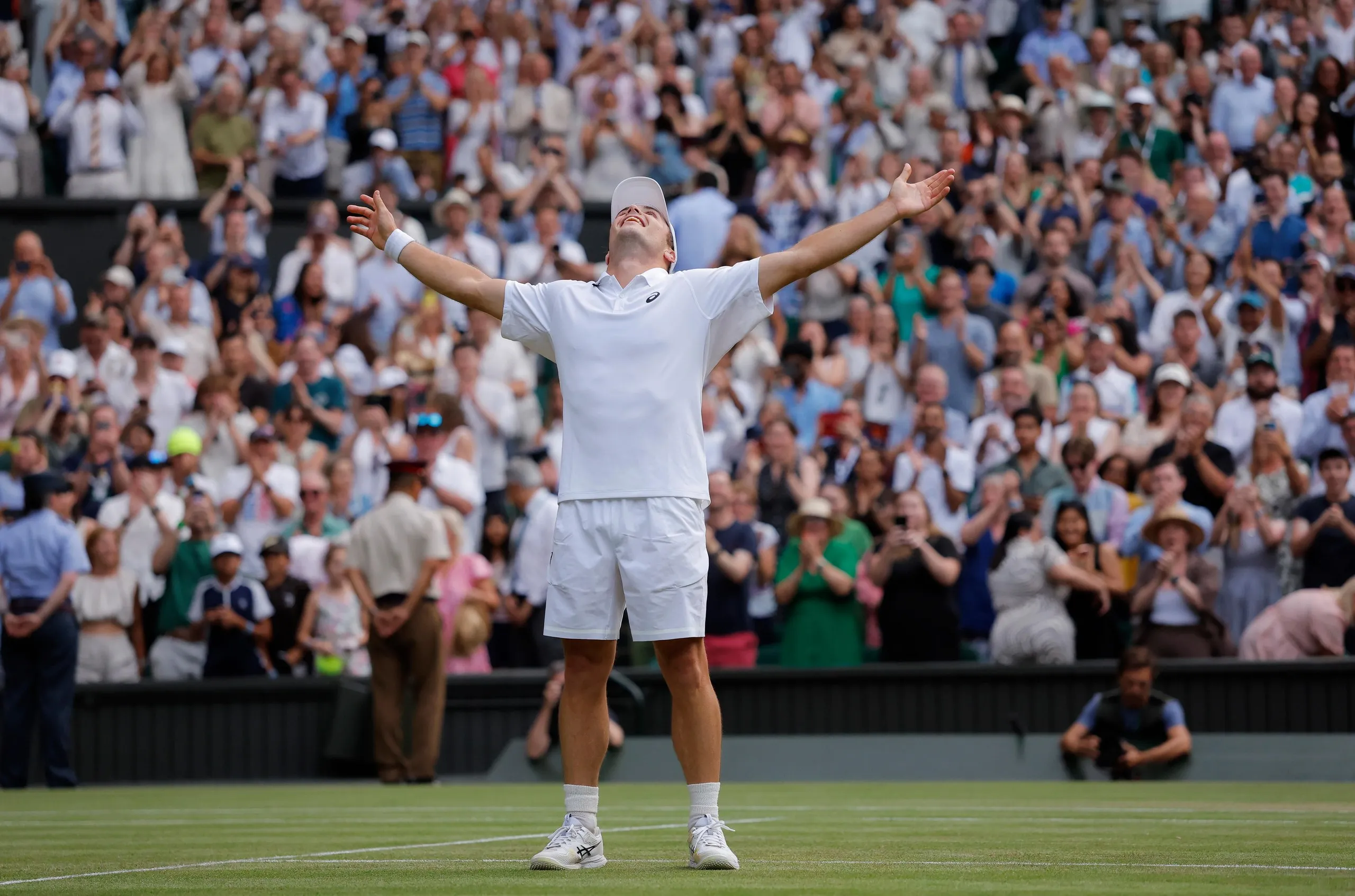 Arthur Fery stretches his arm in celebration after victory over Grigor Dimitrov in five sets on Centre Court during Wimbledon 2026