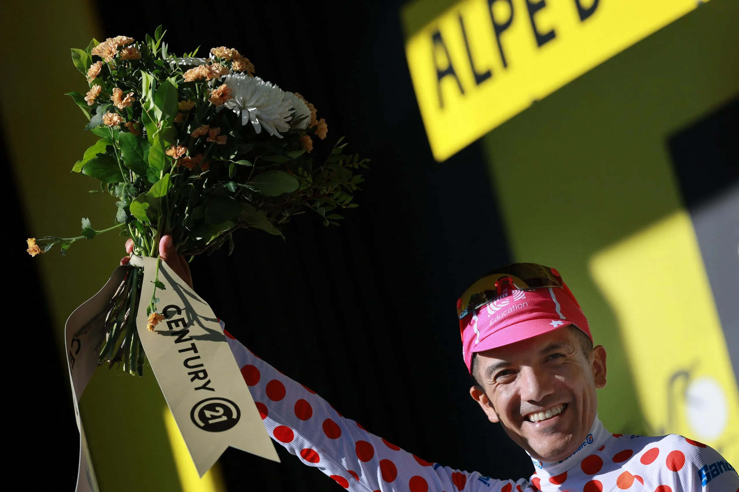 EF Education - EasyPost's Richard Carapaz celebrates on the podium wearing the polka dot jersey after stage 19.