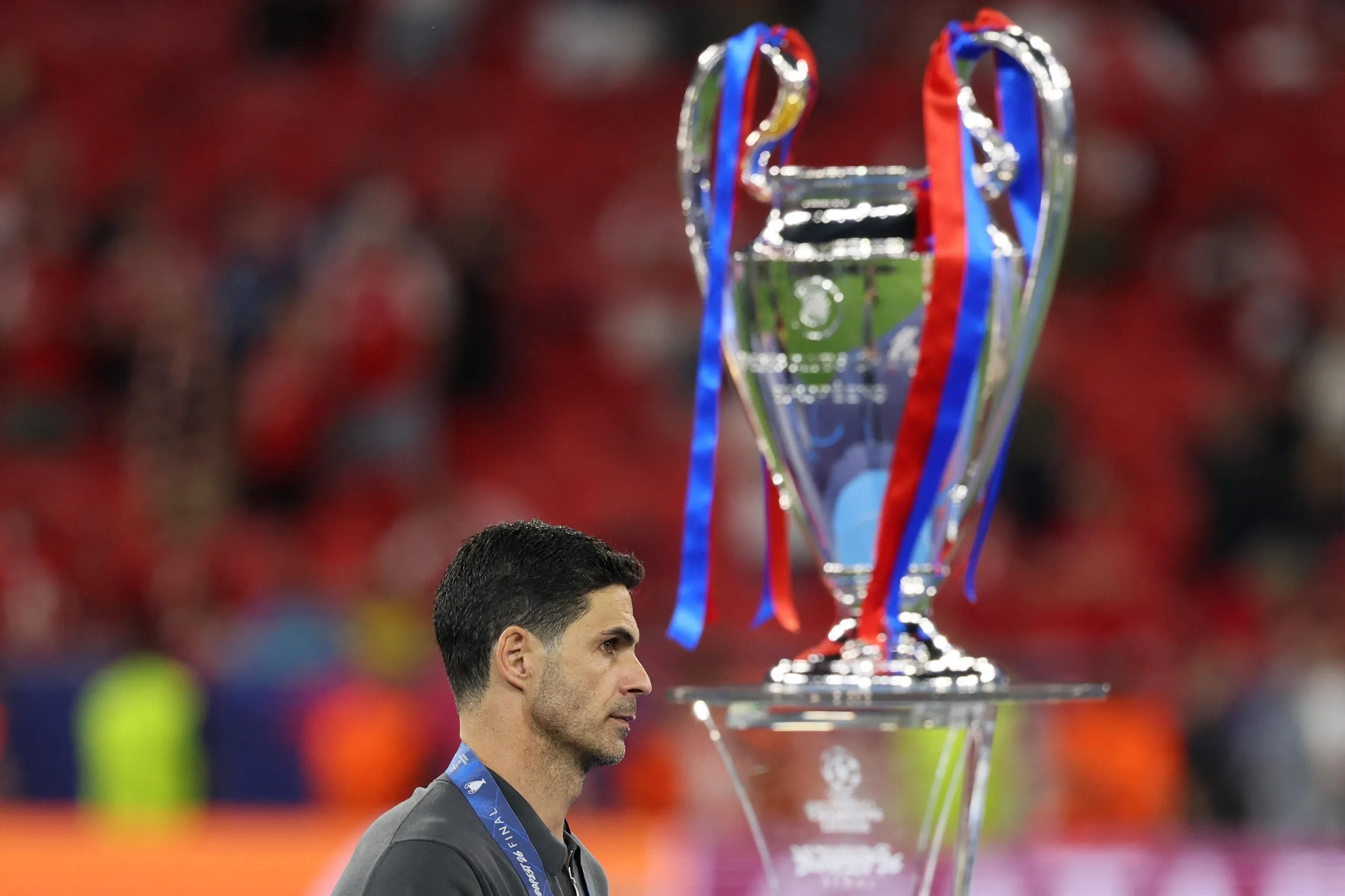 Arsenal’s Mikel Arteta walks past the trophy.