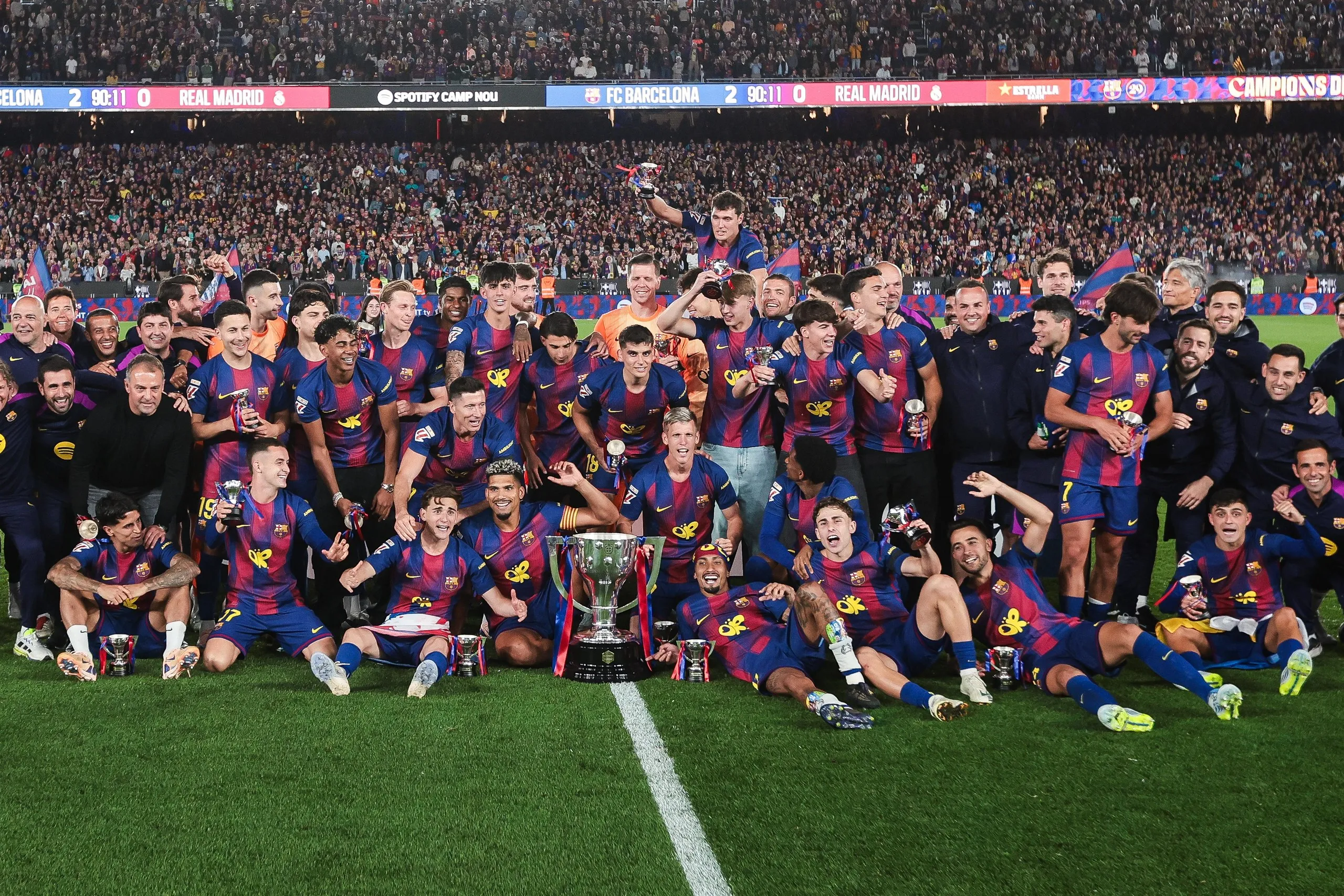 Barcelona players and coaching staff pose for a photo after defeating Real Madrid to secure La Liga