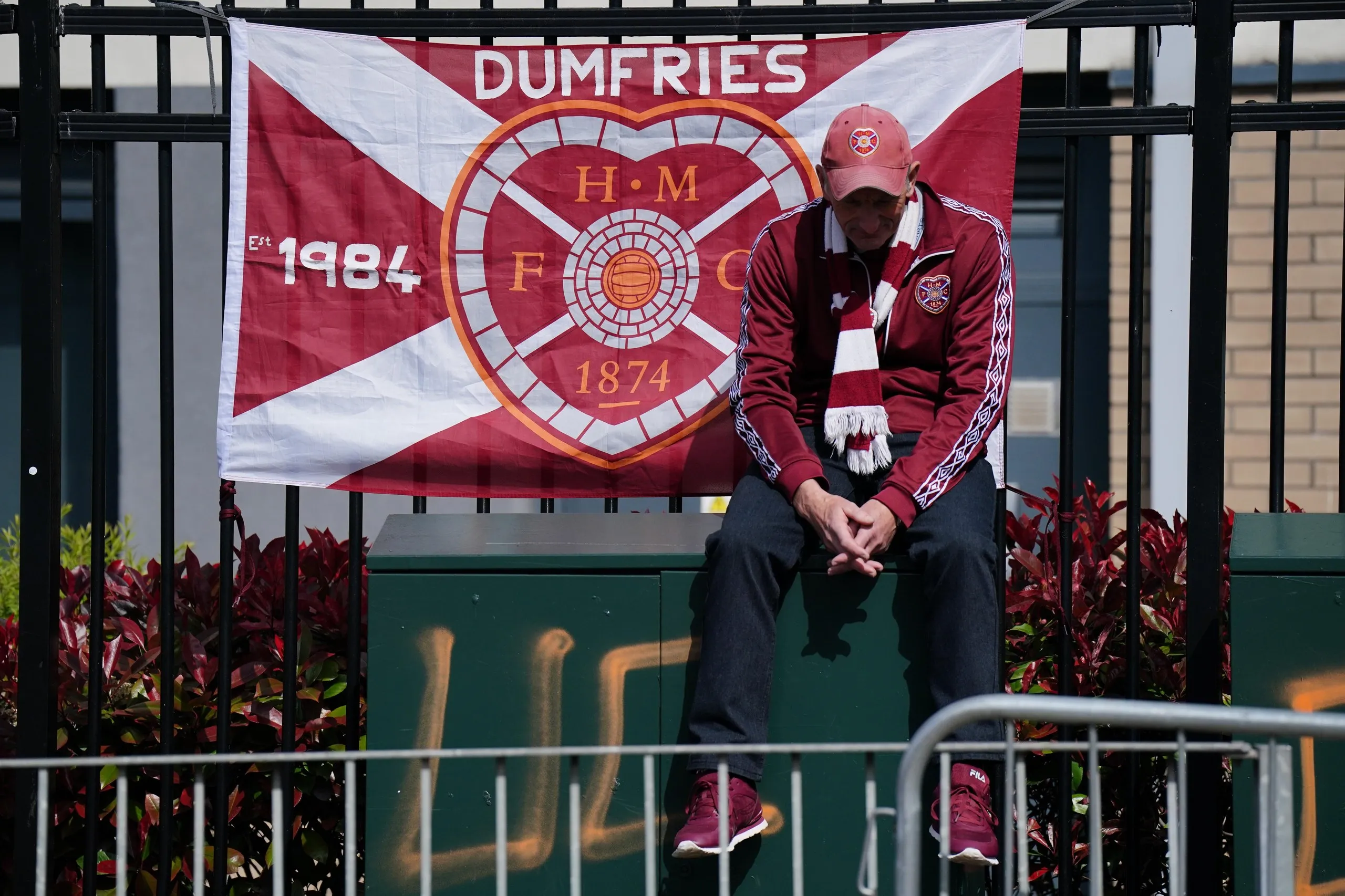 Dejected Heart of Midlothian fan outside their club's stadium in Edinburgh.