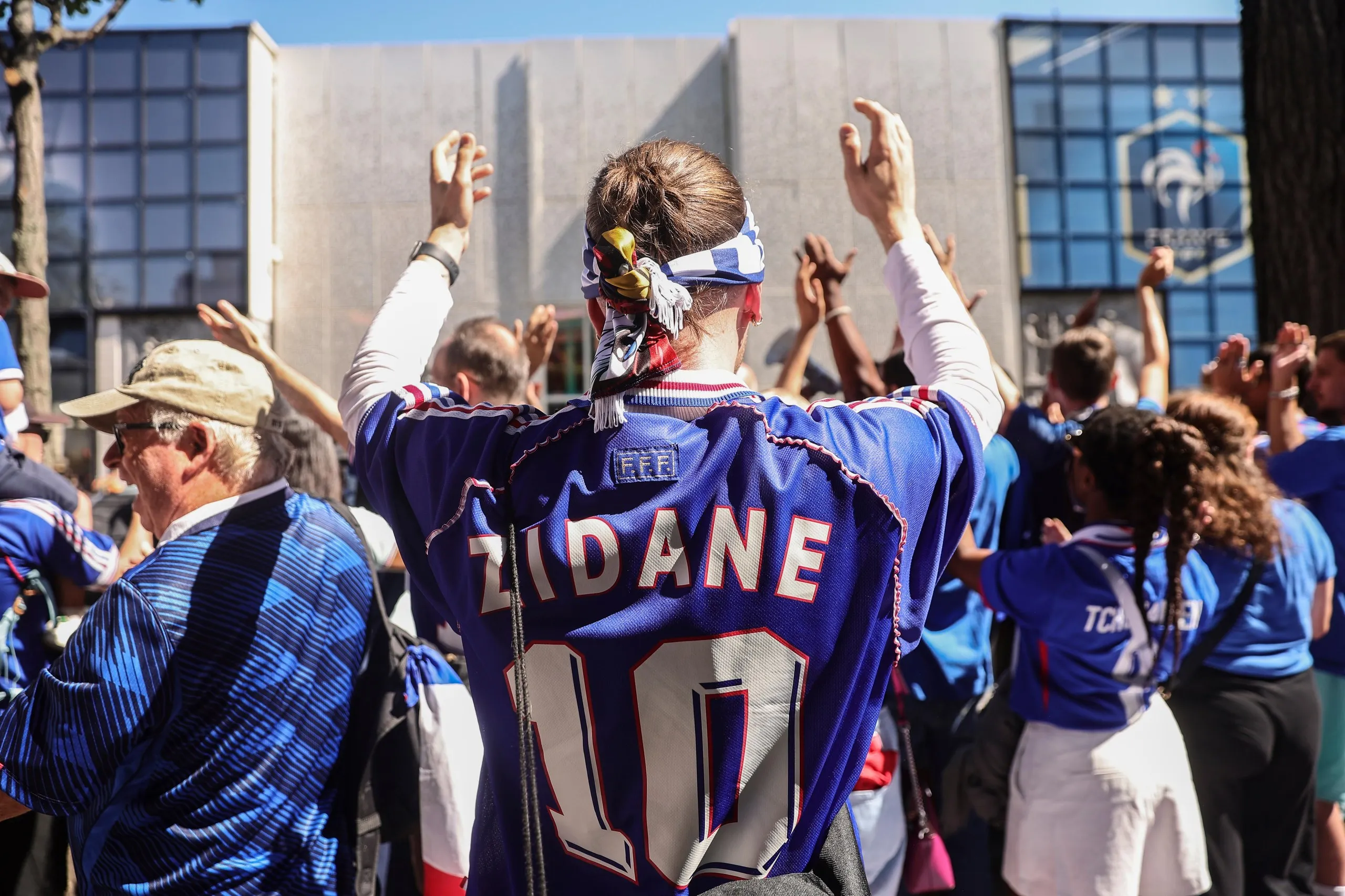 France supporters outside the French football federation’s headquarters, in France shirts, one with 'Zidane 10' on the back