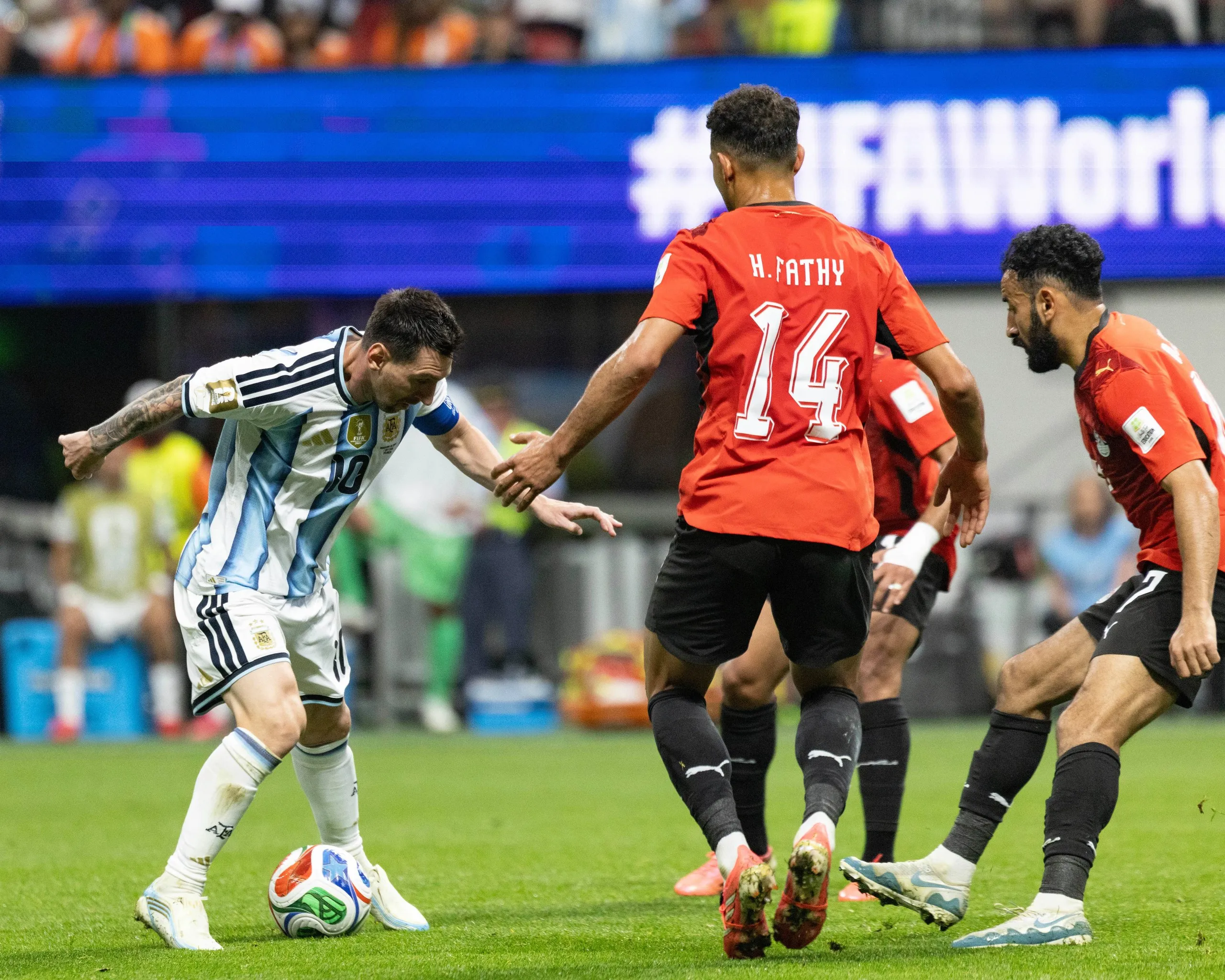 Messi, with the ball at his feet, takes on three Egypt players