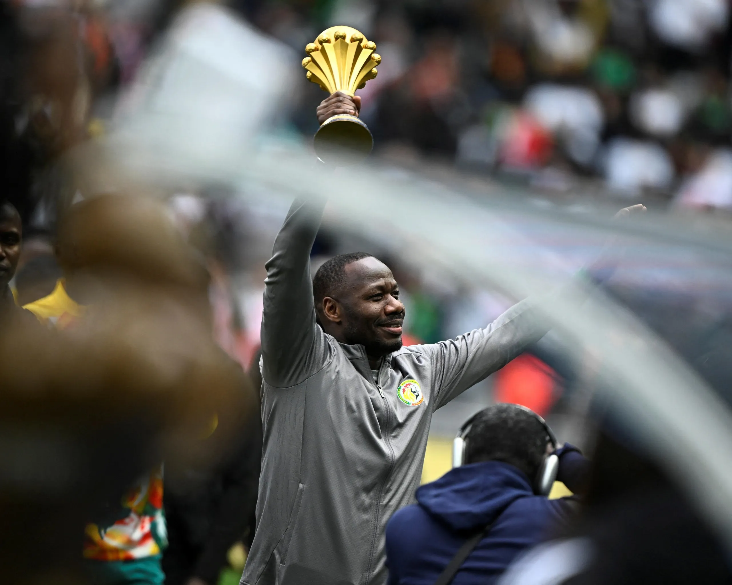 Senegal’s head coach Pape Thiaw holds the Africa Cup of Nations Trophy