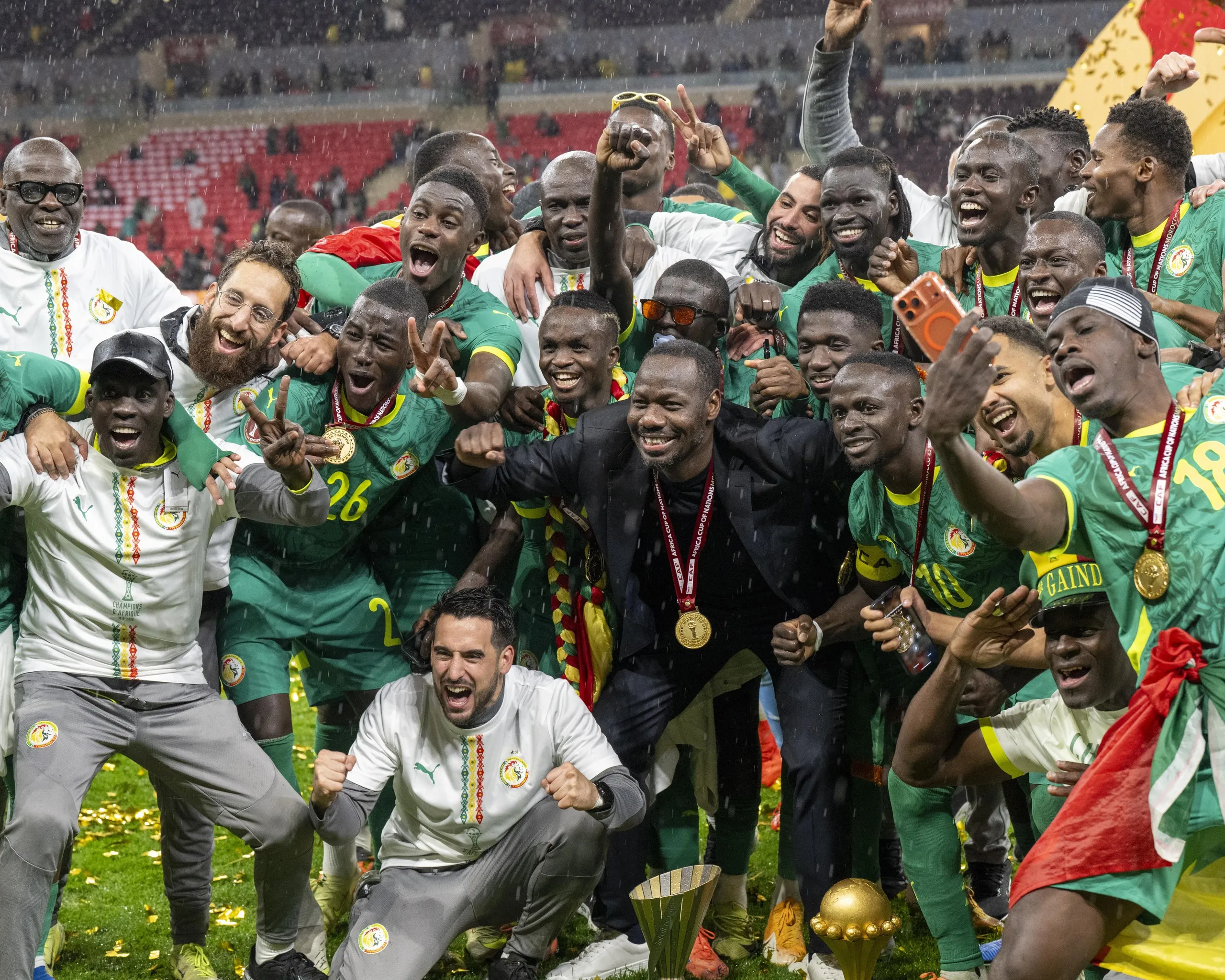 Senegal’s players wearing medals and posing with the cup 