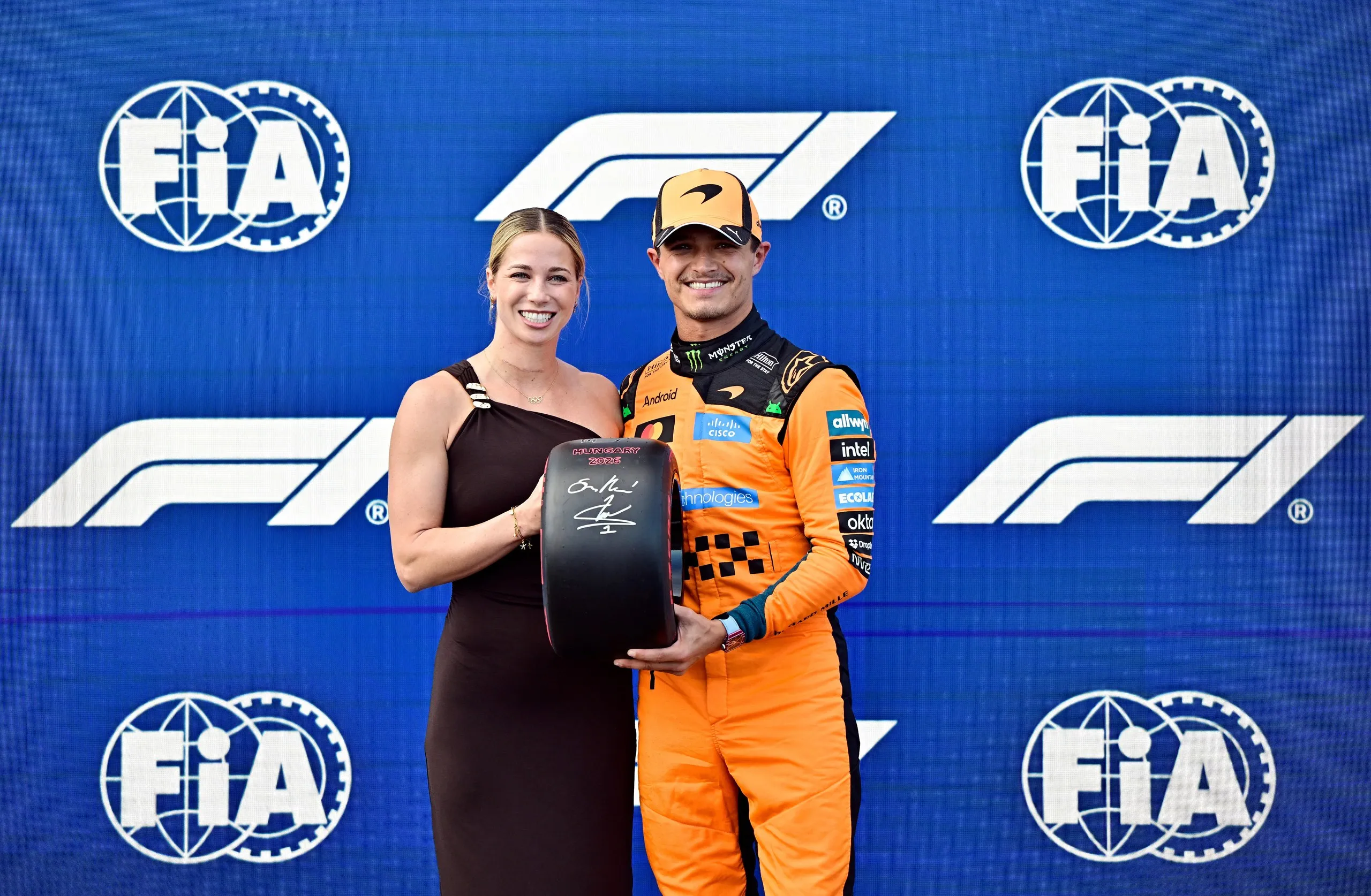 McLaren’s Lando Norris celebrates with a trophy after qualifying in pole position.