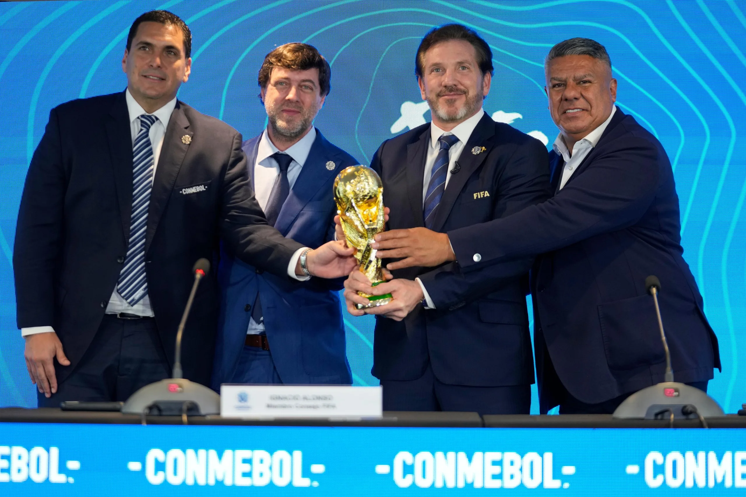 Paraguay’s Robert Harrison, the Fifa delegate Ignacio Alonso, the Conmebol president Alejandro Dominguez and the Conmebol vice-president Claudio Tapia hold the World Cup in Luque, Paraguay, on Wednesday 4 October 2023