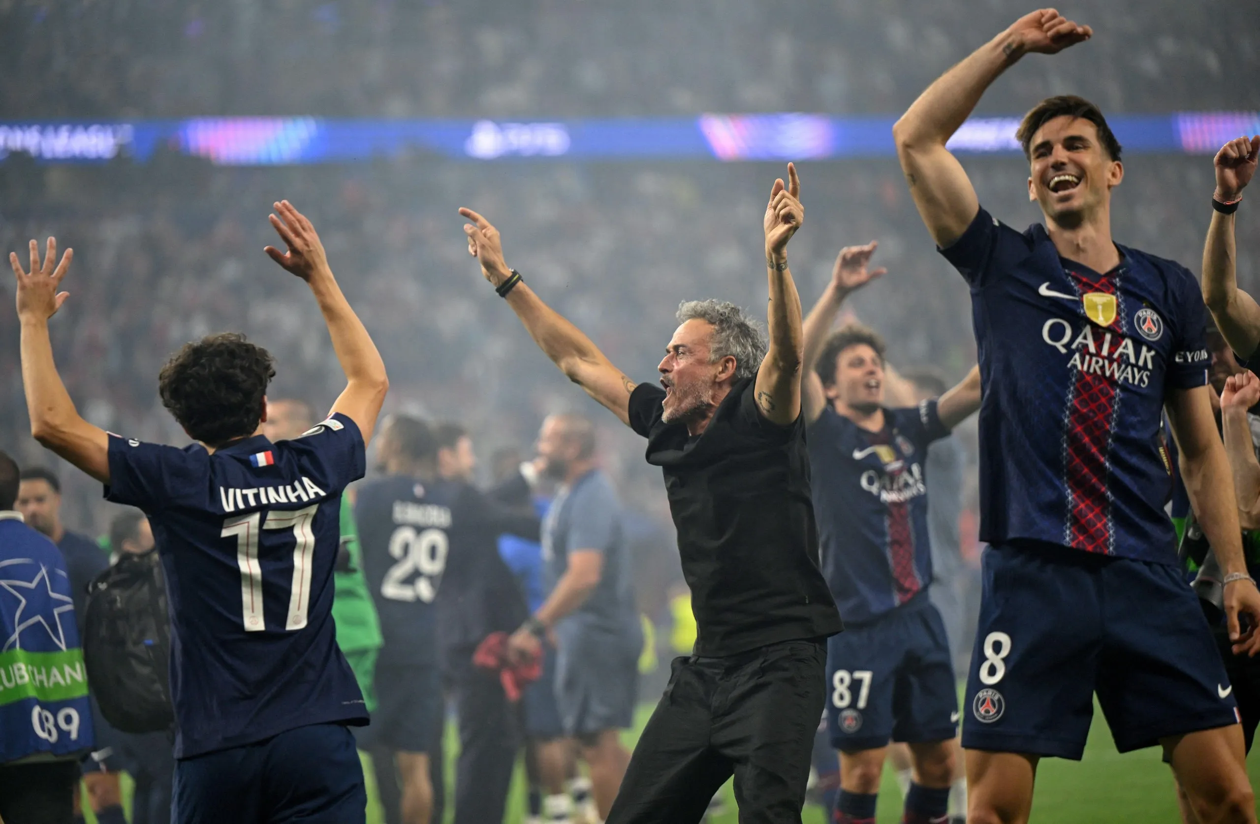 Paris Saint-Germain’s head coach Luis Enrique (centre) celebrates alongside Fabian Ruiz (right) and other team members.