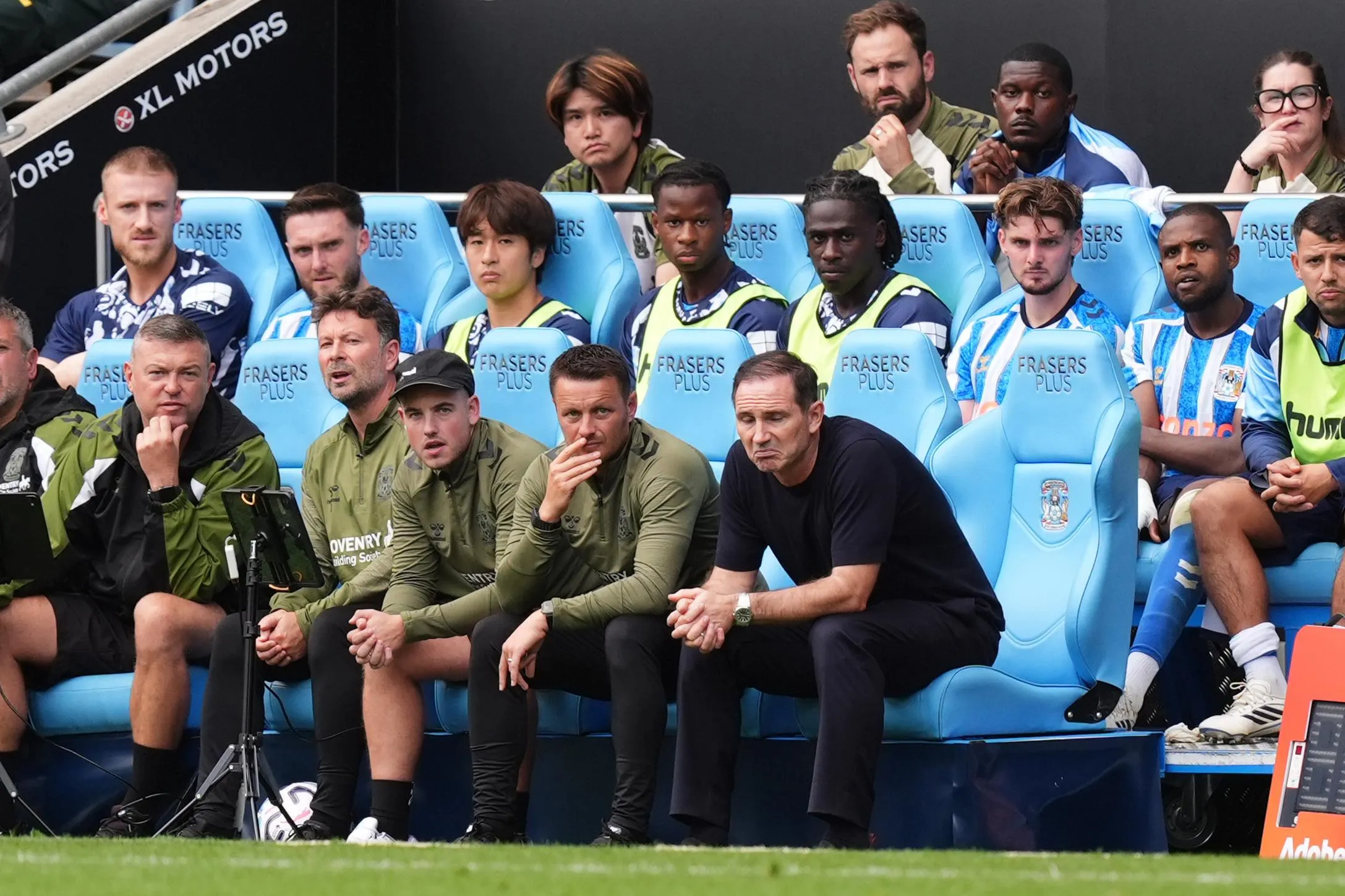 Frank Lampard sits in the dugout.