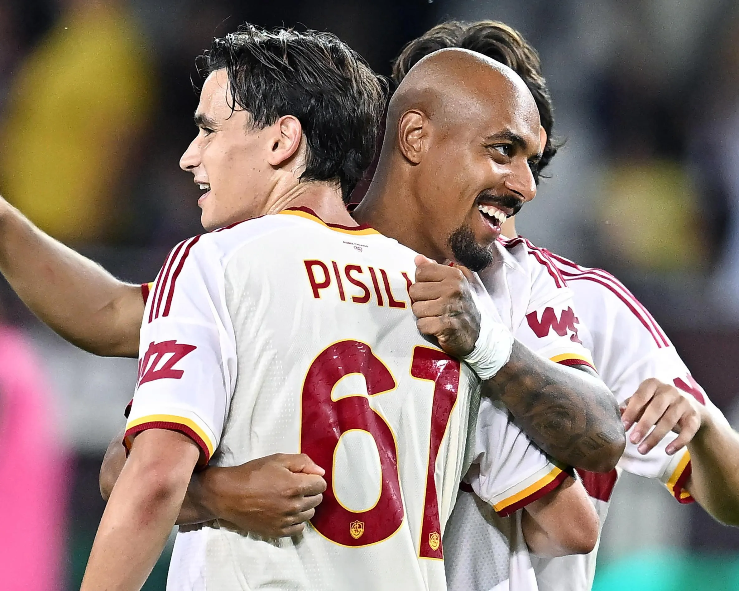 Roma scorers Niccolò Pisilli and Donyell Malen celebrate at the final whistle.