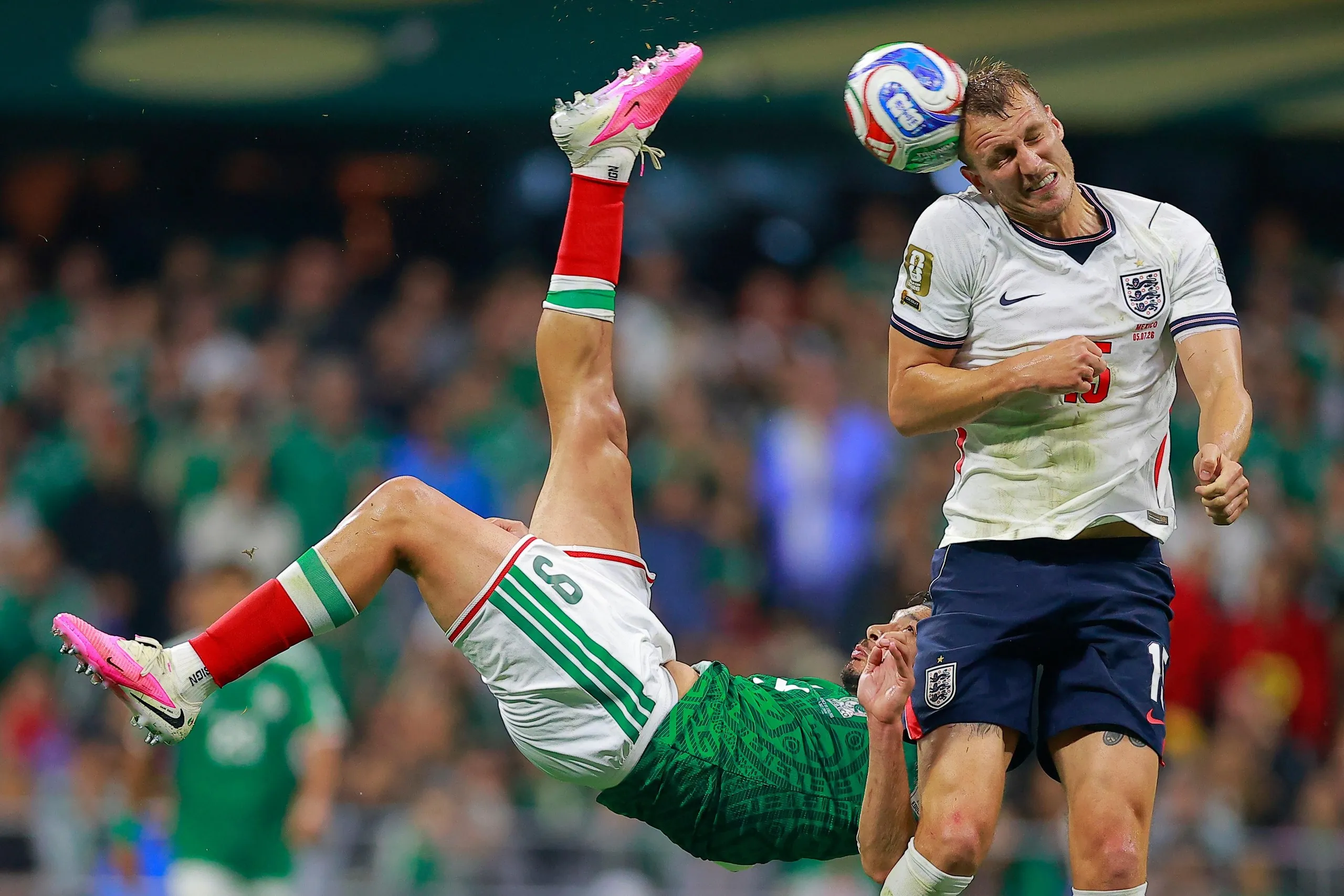 Dan Burn of England blocks a bicycle kick from Raúl Jiménez with his head