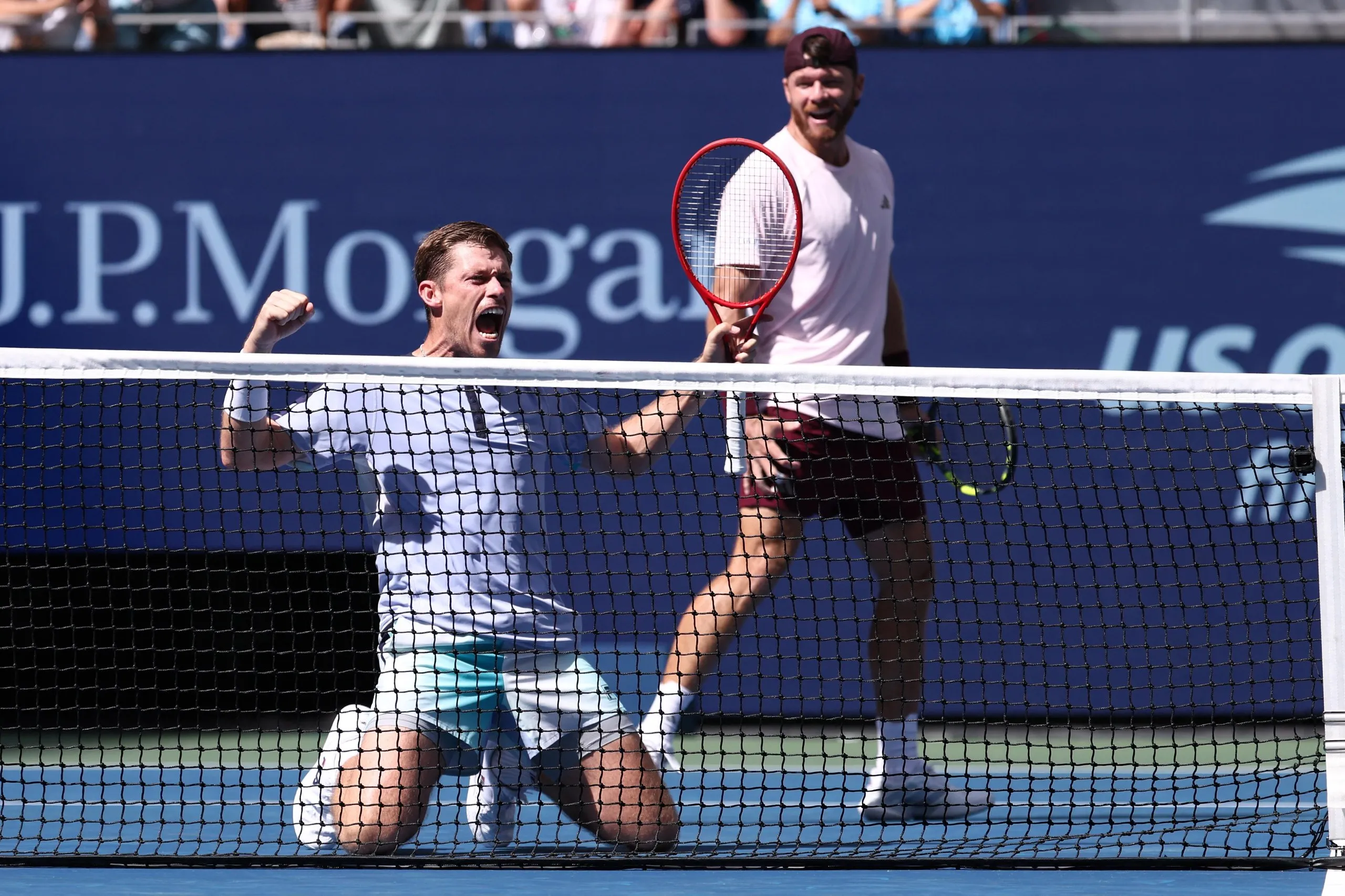 (L/R) Britain's Neal Skupski and USA's Christian Harrison react in celebration after defeating Germany's Kevin Krawietz and Tim Puetz during the men's doubles final match.