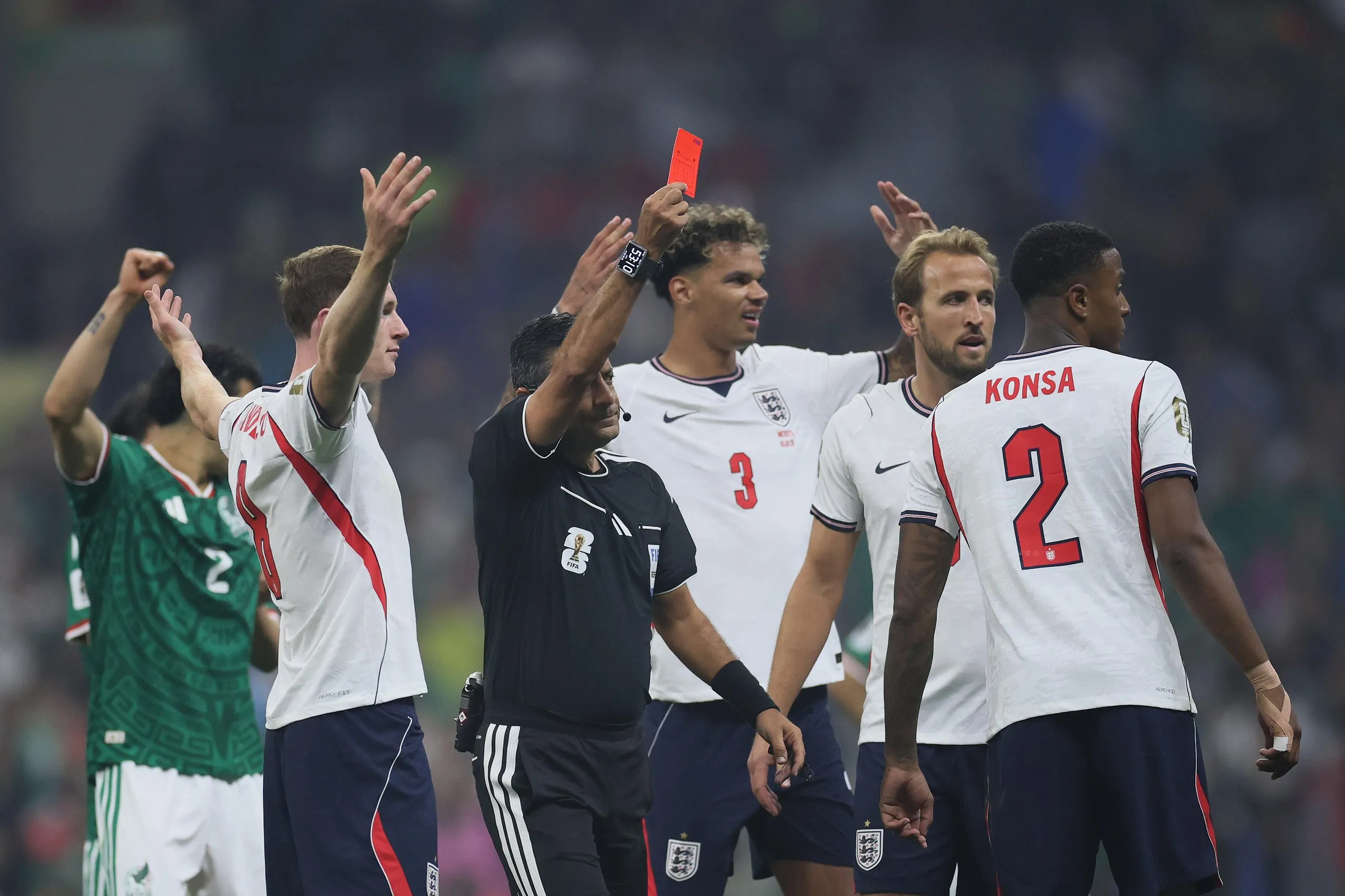 Surrounded by England players, Alireza Faghani shows a red card