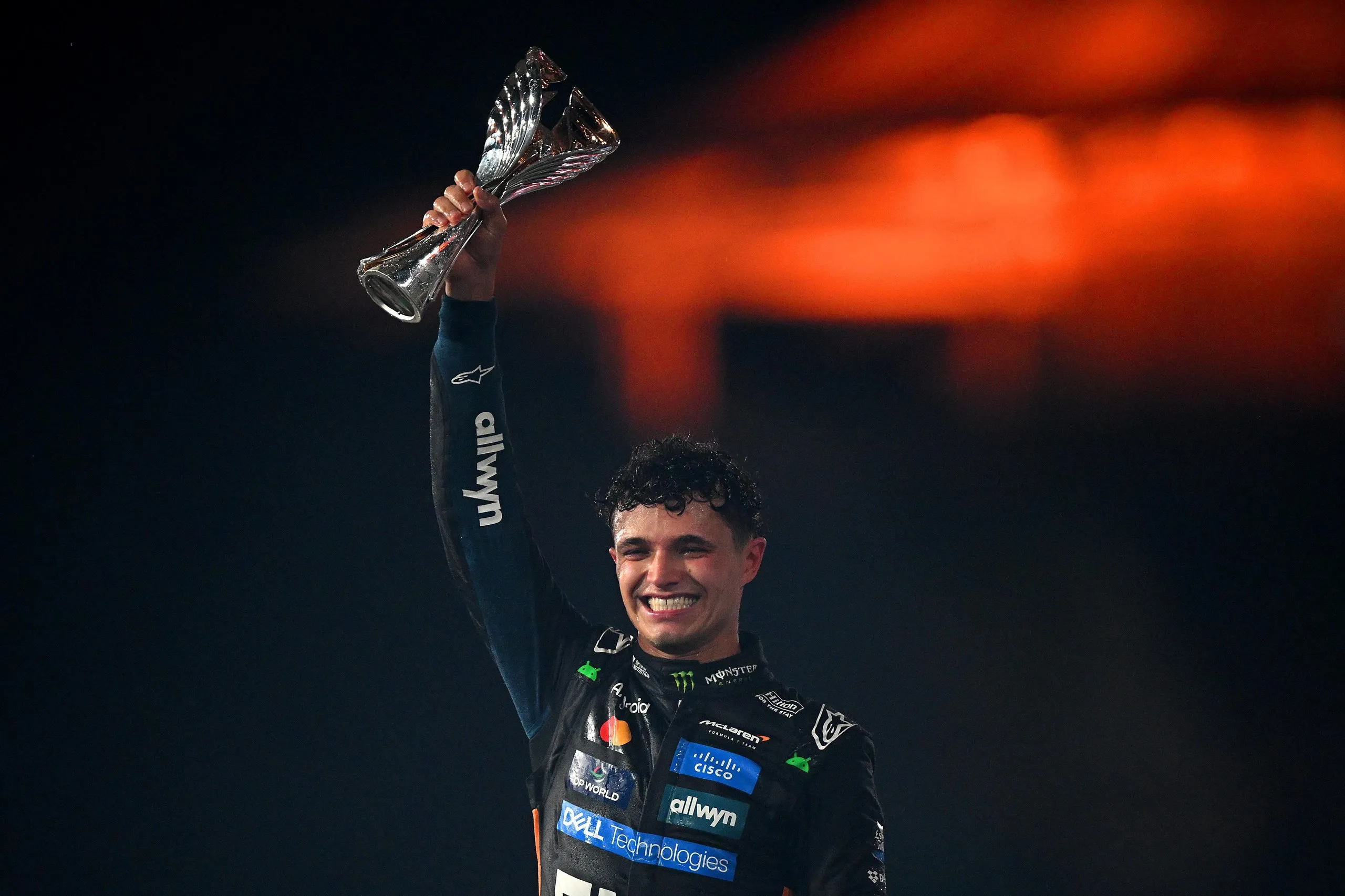 Lando Norris lifts the F1 Championship trophy on the podium at the Abu Dhabi Grand Prix at Yas Marina Circuit