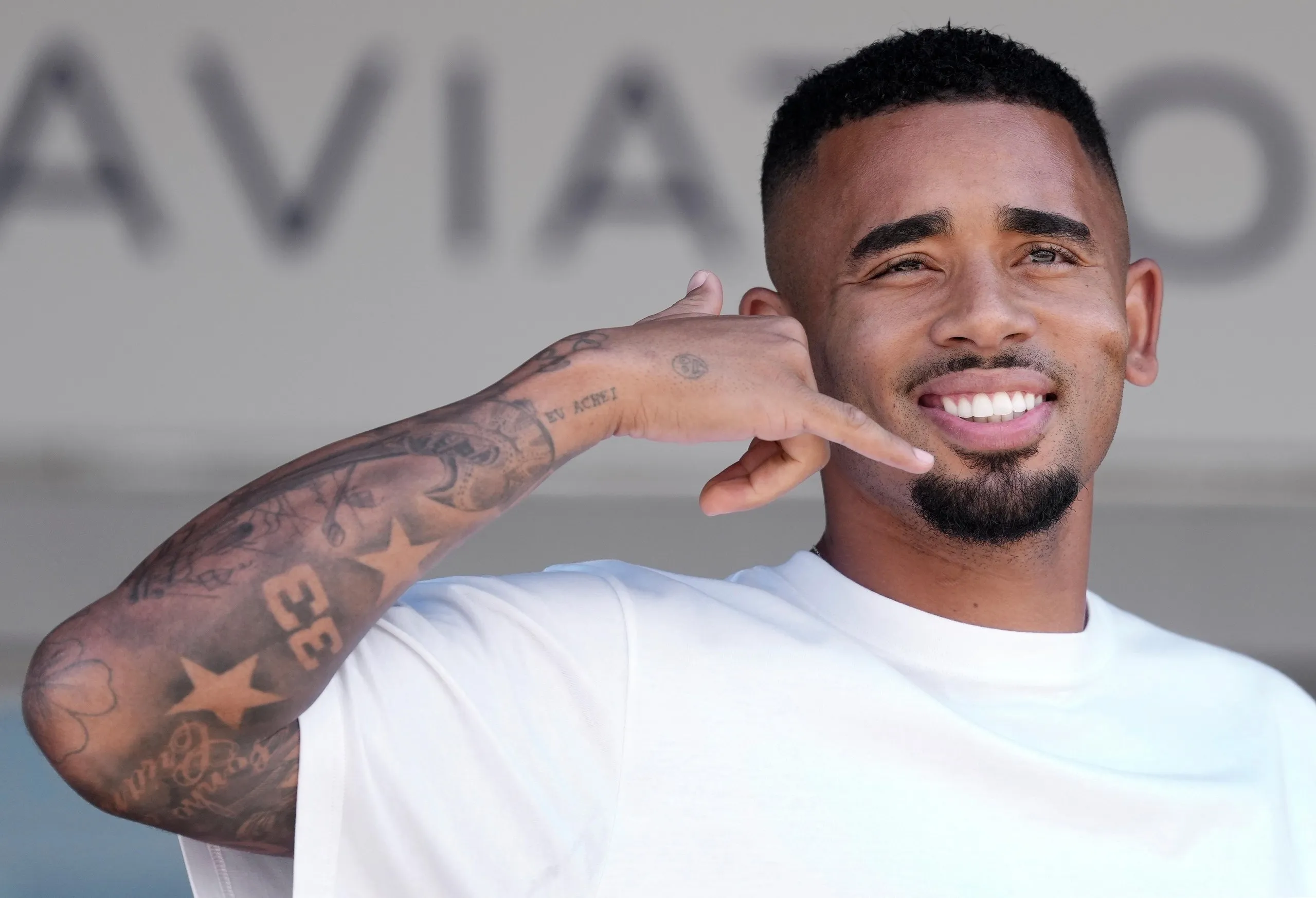 Gabriel Jesus gestures upon arrival at the airport in Barcelona