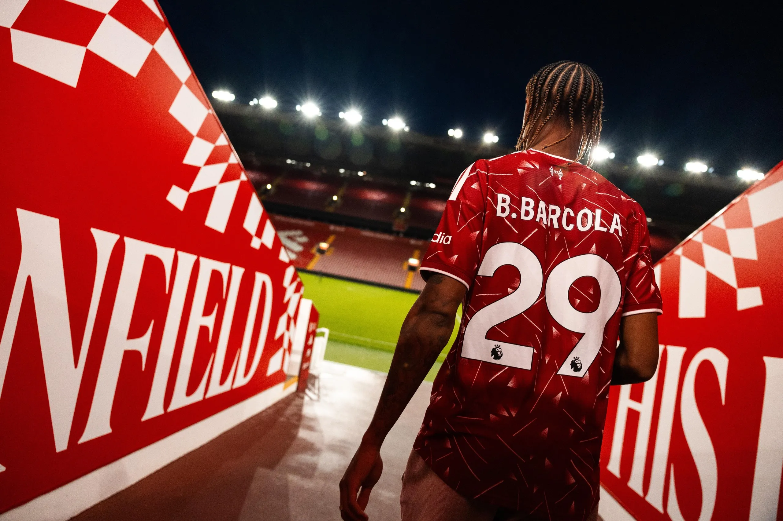 Bradley Barcola pictured walking towards the Anfield pitch