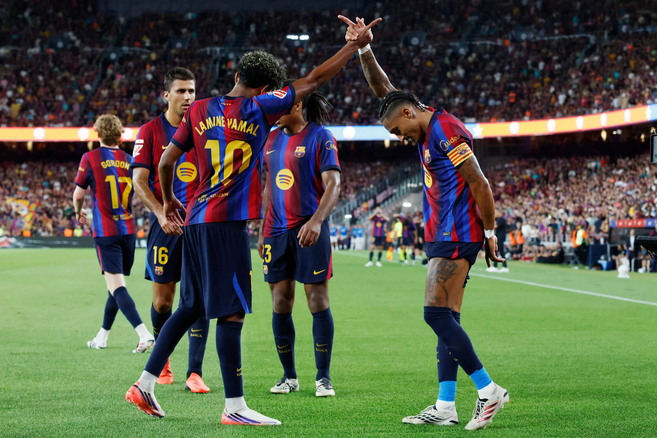 Raphinha (right) celebrates scoring with Lamine Yamal