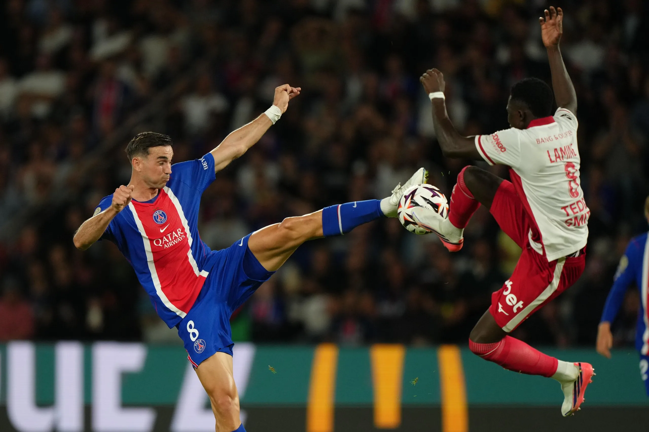 PSG’s Fabian Ruiz (left) challenges for the ball with Monaco’s in-demand Lamine Camara.